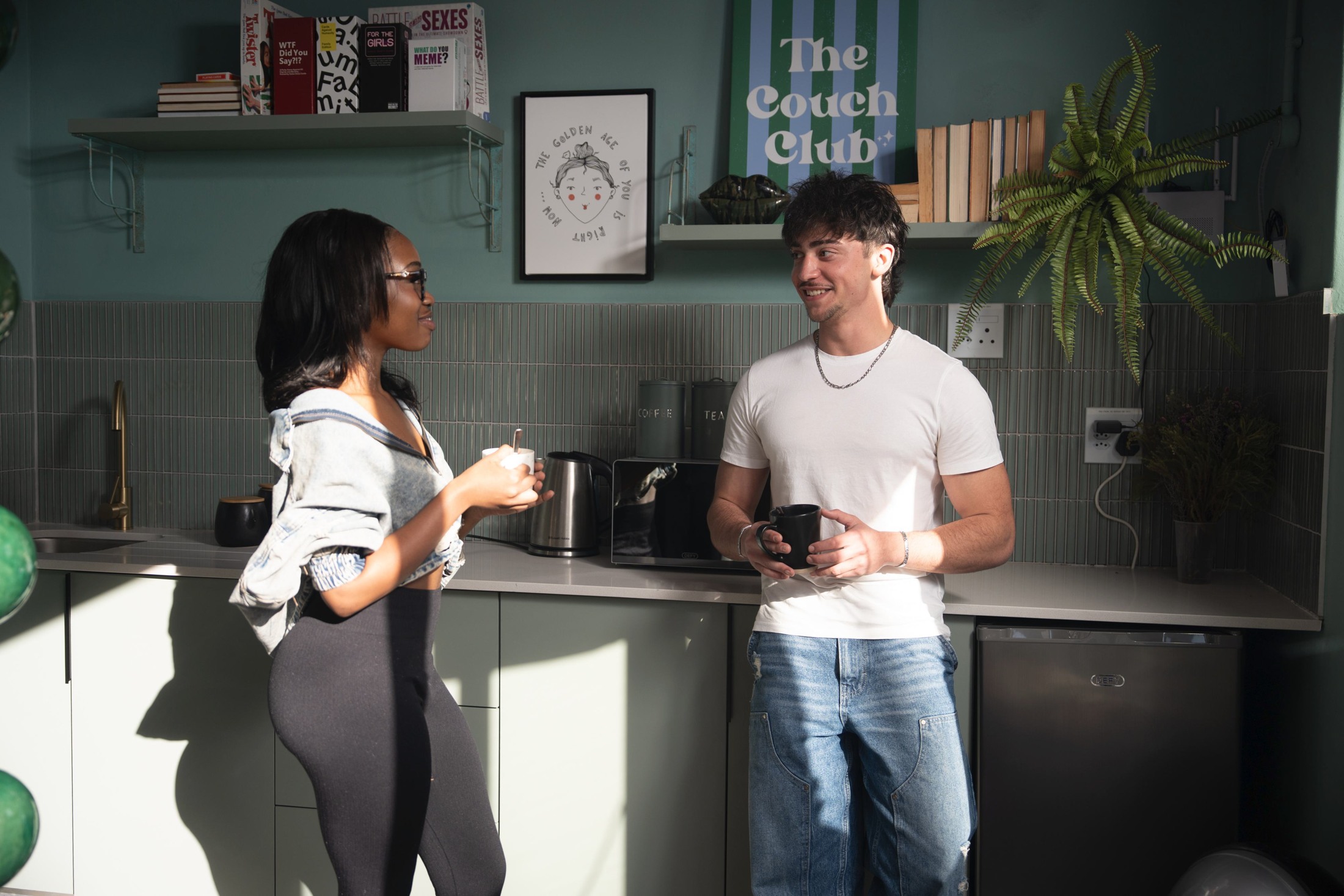 Residents in the shared kitchen and coffee area at Main Road.