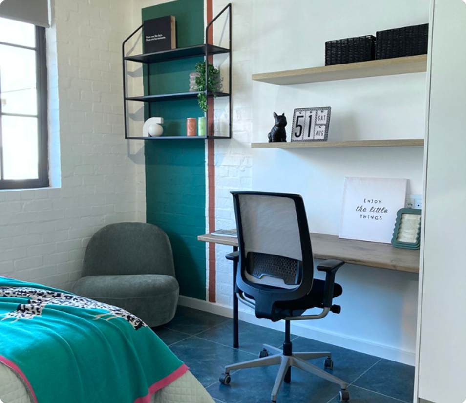 Verreweide two-bedroom unit, teal bedroom desk and bookshelves.