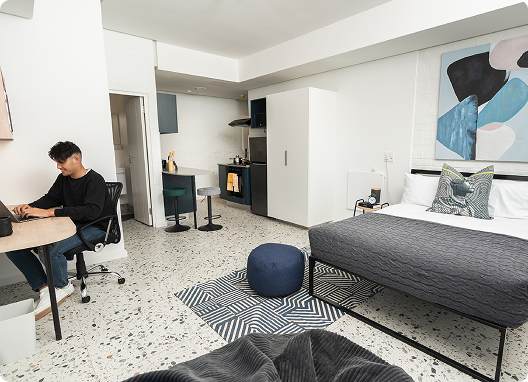 Student studying in a residence bedroom