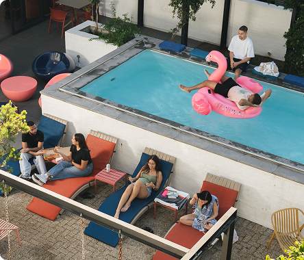 Residents relaxing beside the courtyard pool
