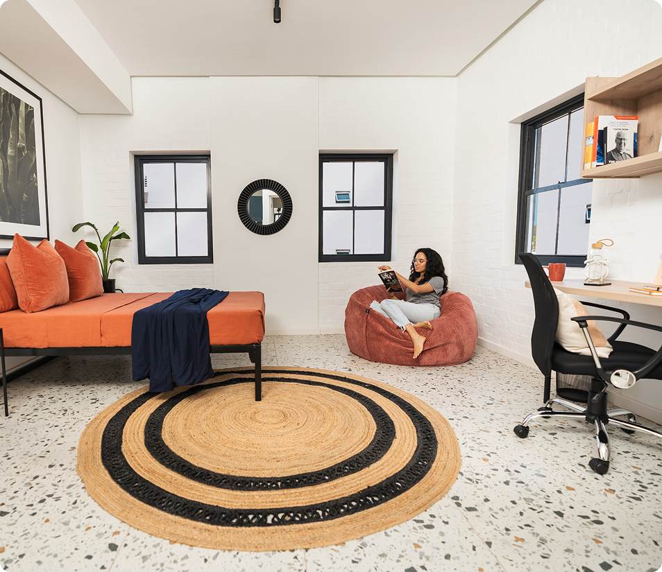 XL Bachelor bedroom and desk, orange bedding at Lovers Walk.